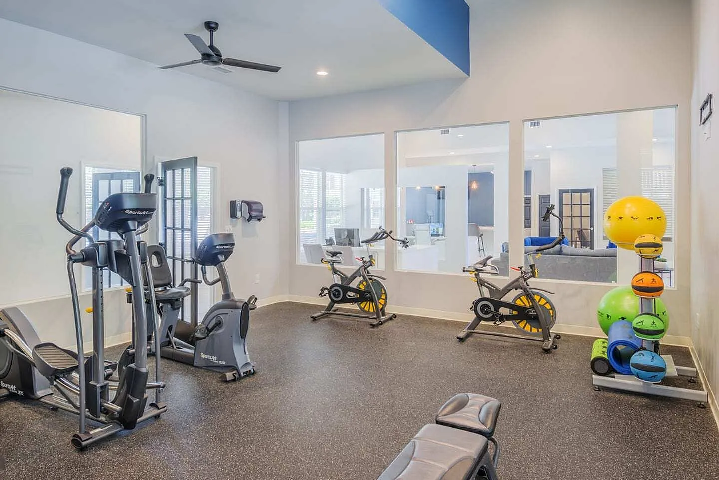 Fitness center, cardio equipment, stationary bikes, exercise balls, ceiling fan