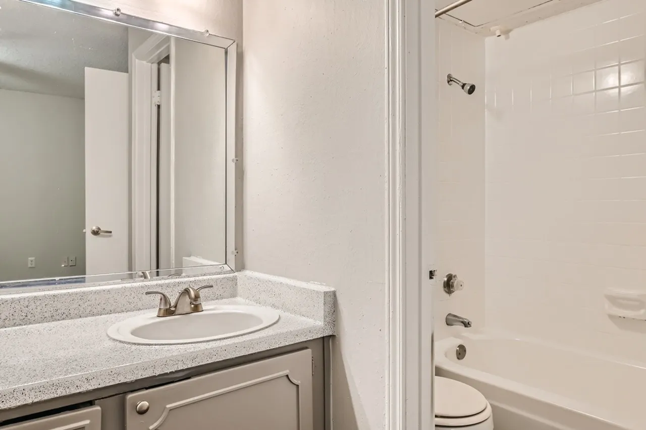 Bathroom, white vanity cabinet, quartz countertop, vessel sink, framed mirror