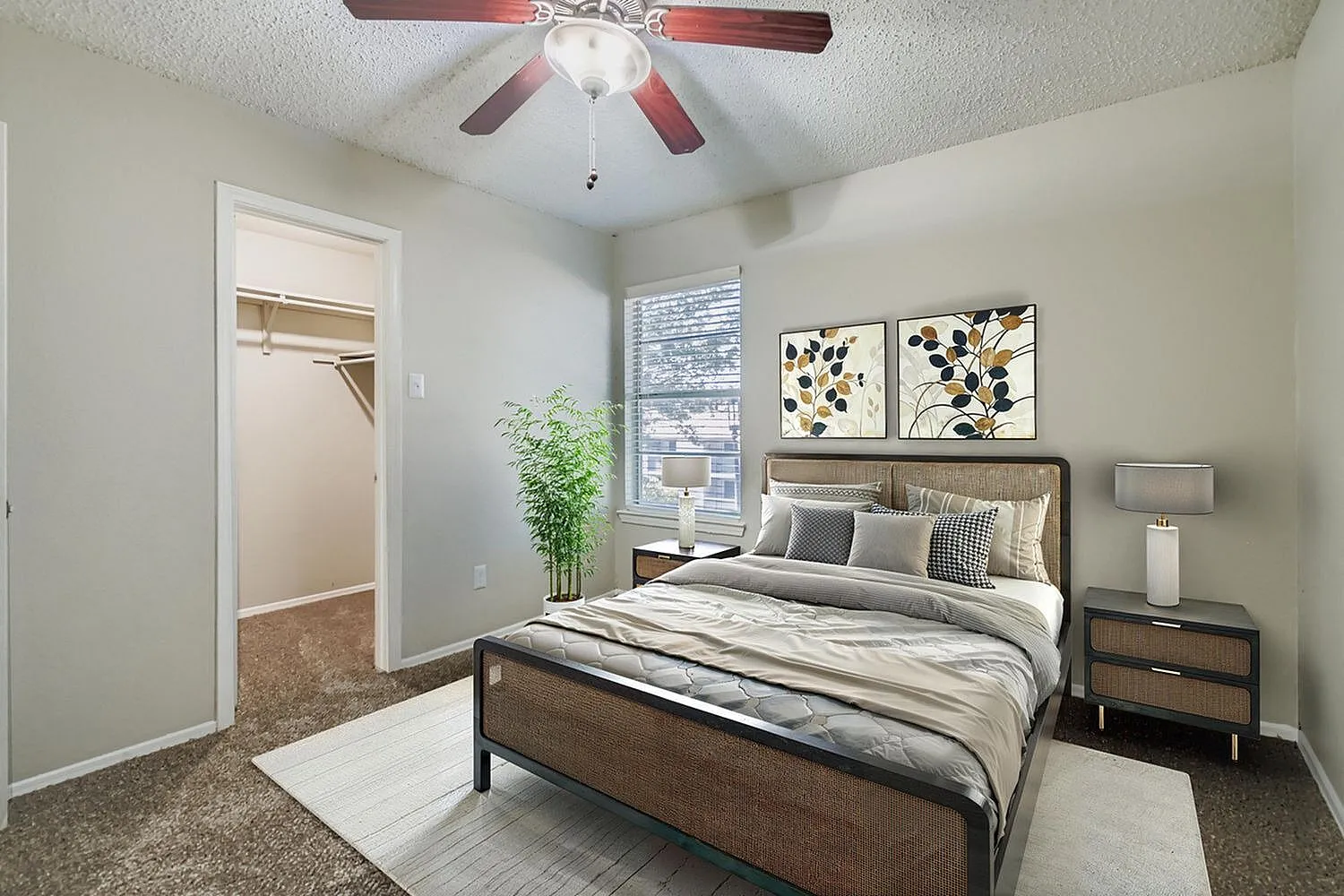 Primary bedroom, wood-style plank flooring, ceiling fan, botanical wall art