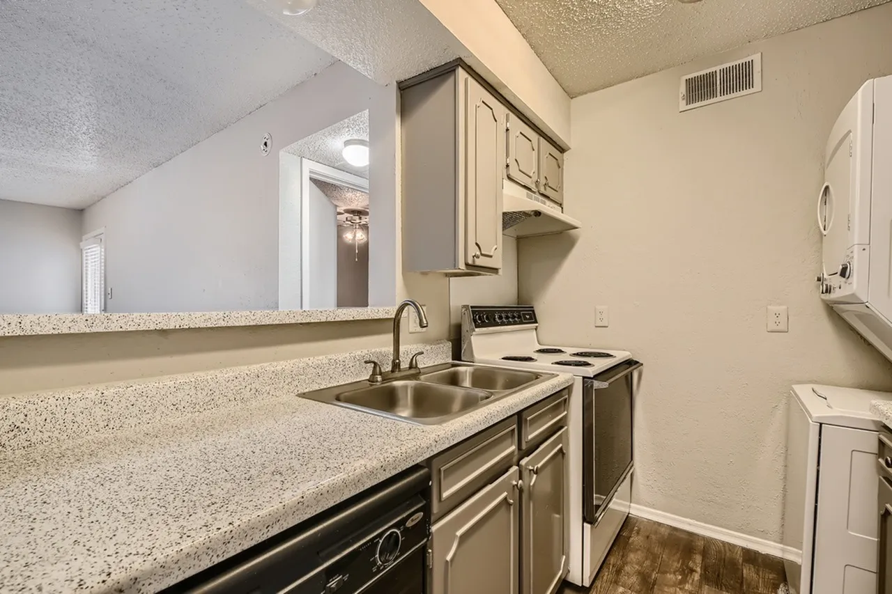 Kitchen, granite countertops, dark cabinetry, stainless steel sink, white appliances, wood-style plank flooring