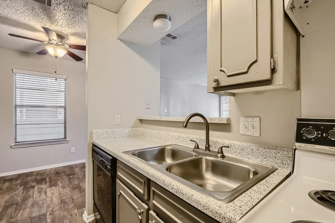 Kitchen, granite countertops, stainless steel sink, dark cabinetry, wood-style plank flooring