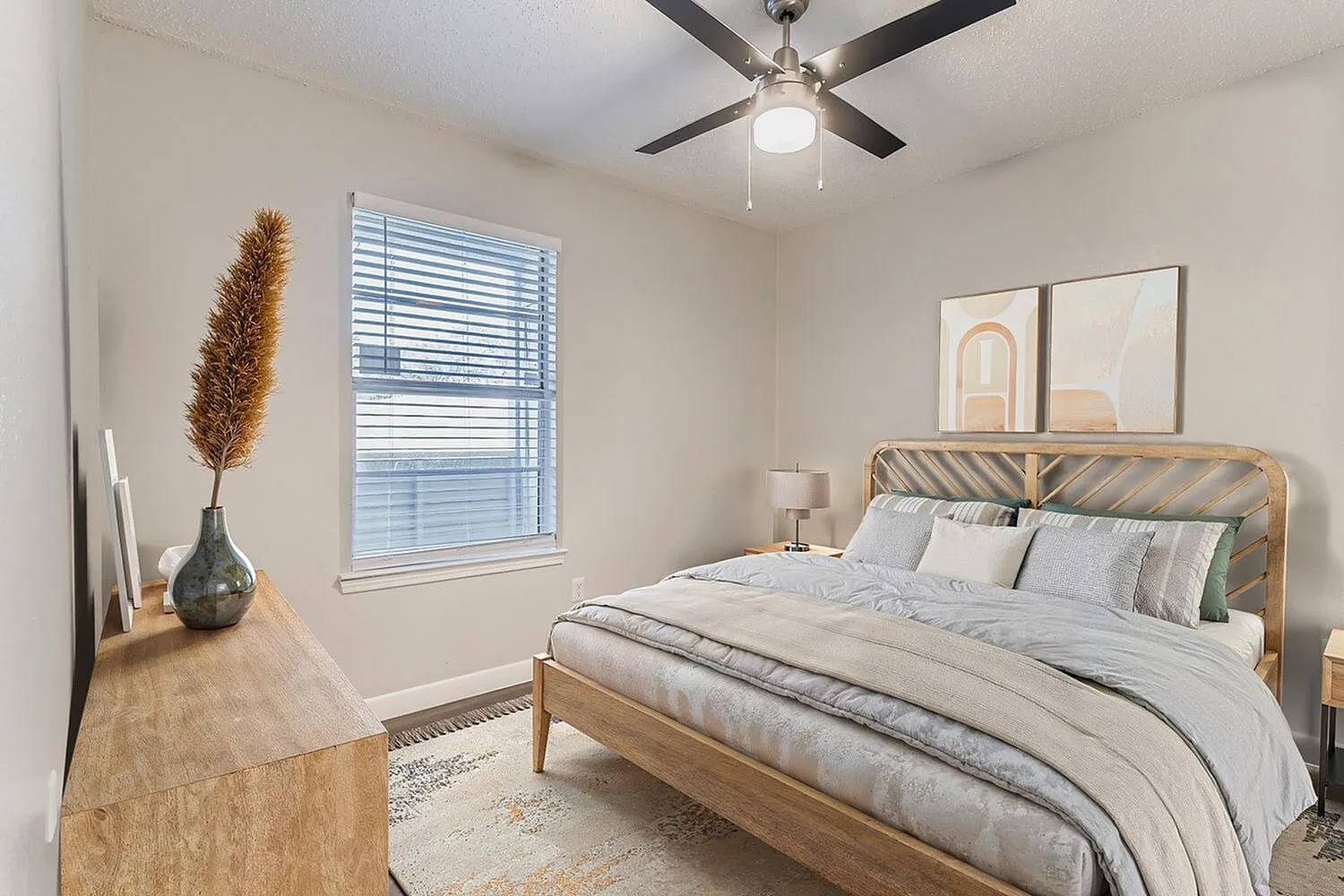 Primary bedroom, wood-style plank flooring, ceiling fan with light, wood bed frame
