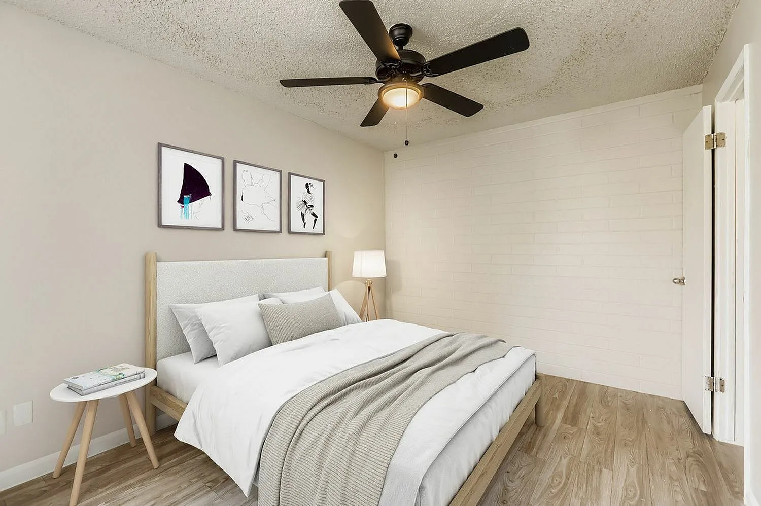 Primary bedroom, wood-style plank flooring, ceiling fan with light, framed wall art