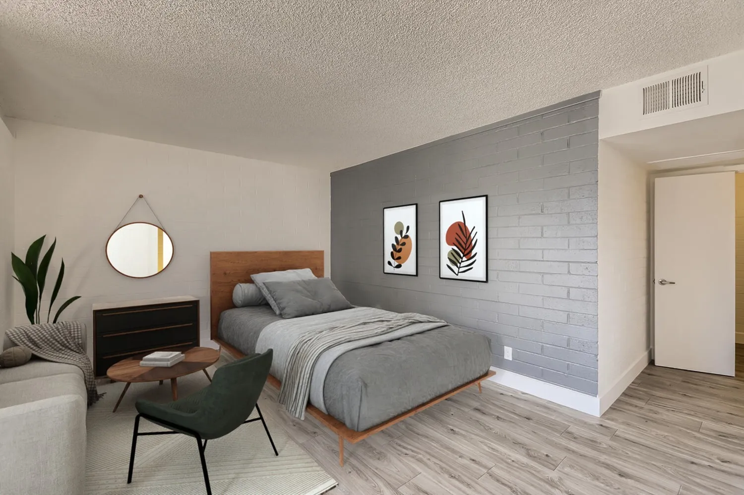 Primary bedroom, gray brick accent wall, wood-style plank flooring, pendant mirror, botanical wall art