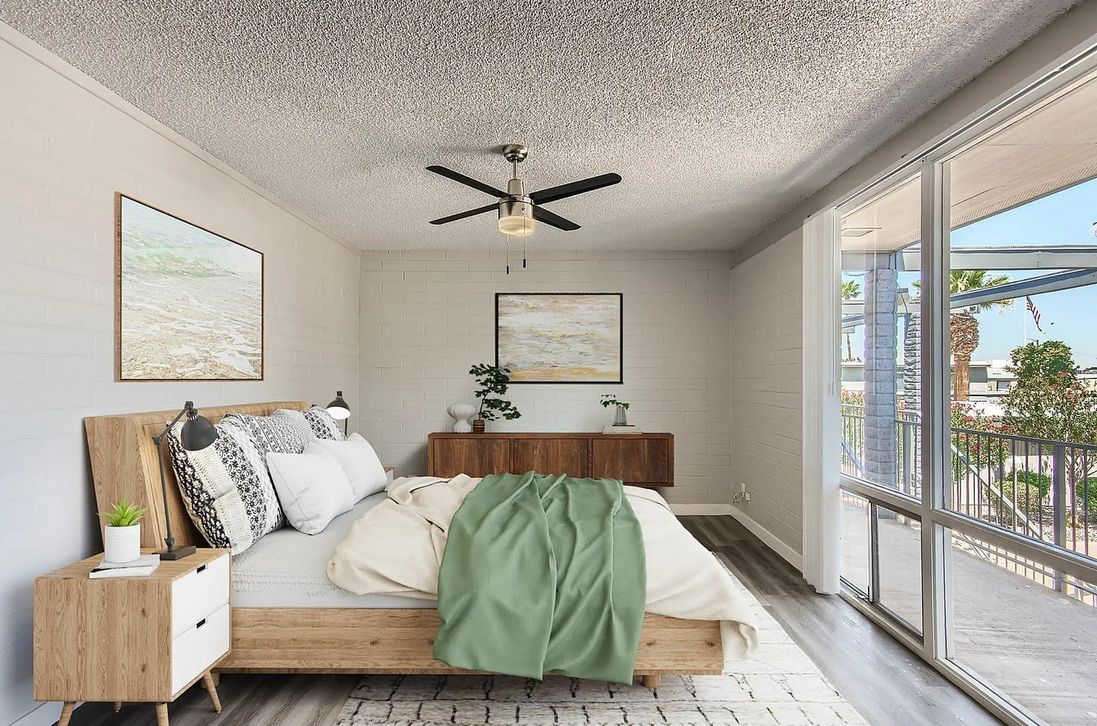 Primary bedroom, wood-style plank flooring, ceiling fan, glass patio doors, wood nightstand