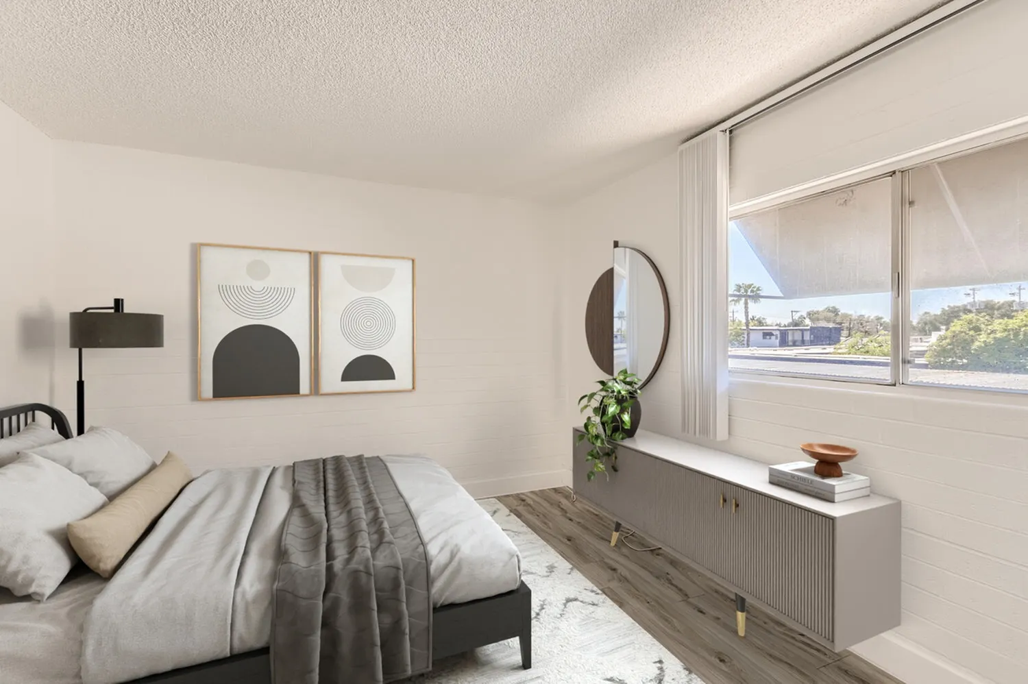 Primary bedroom, wood-style plank flooring, floor-to-ceiling windows, round mirror accent, abstract wall art