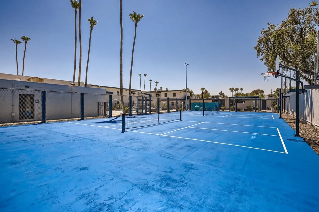Basketball courts, blue playing surface, tall palm trees, light poles, Phoenix