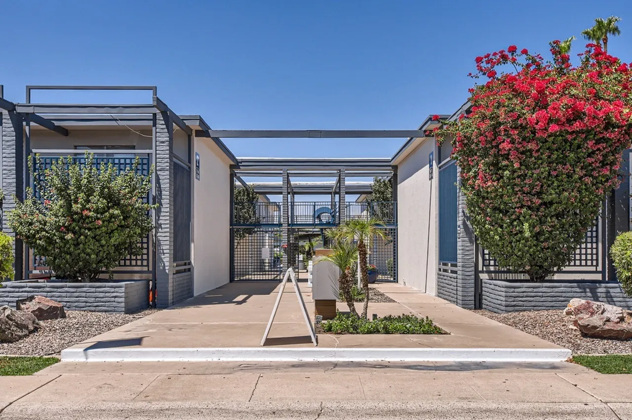 Courtyard with pergola structures, blooming red flowers, desert landscaping, Phoenix