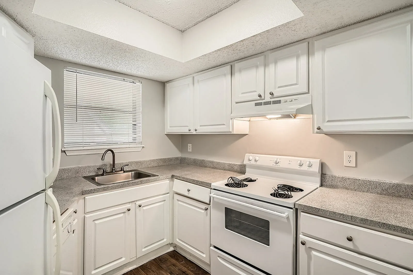 Kitchen, white shaker cabinetry, gray quartz countertops, white appliances, wood-style plank flooring