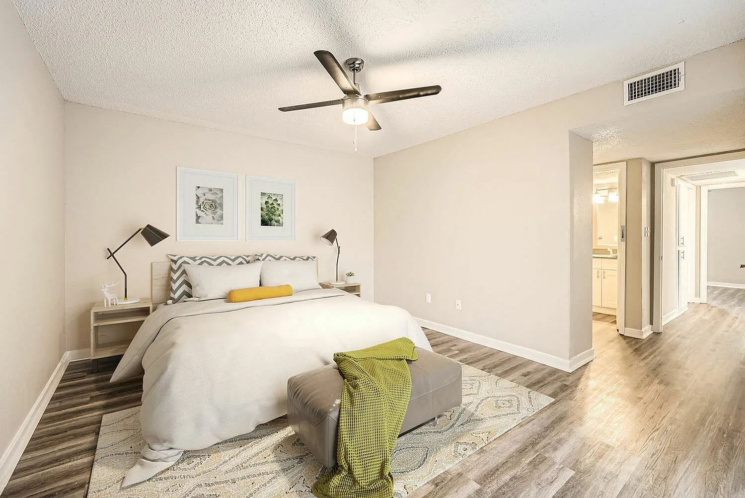 Primary bedroom, wood-style plank flooring, ceiling fan with light fixture, nightstands