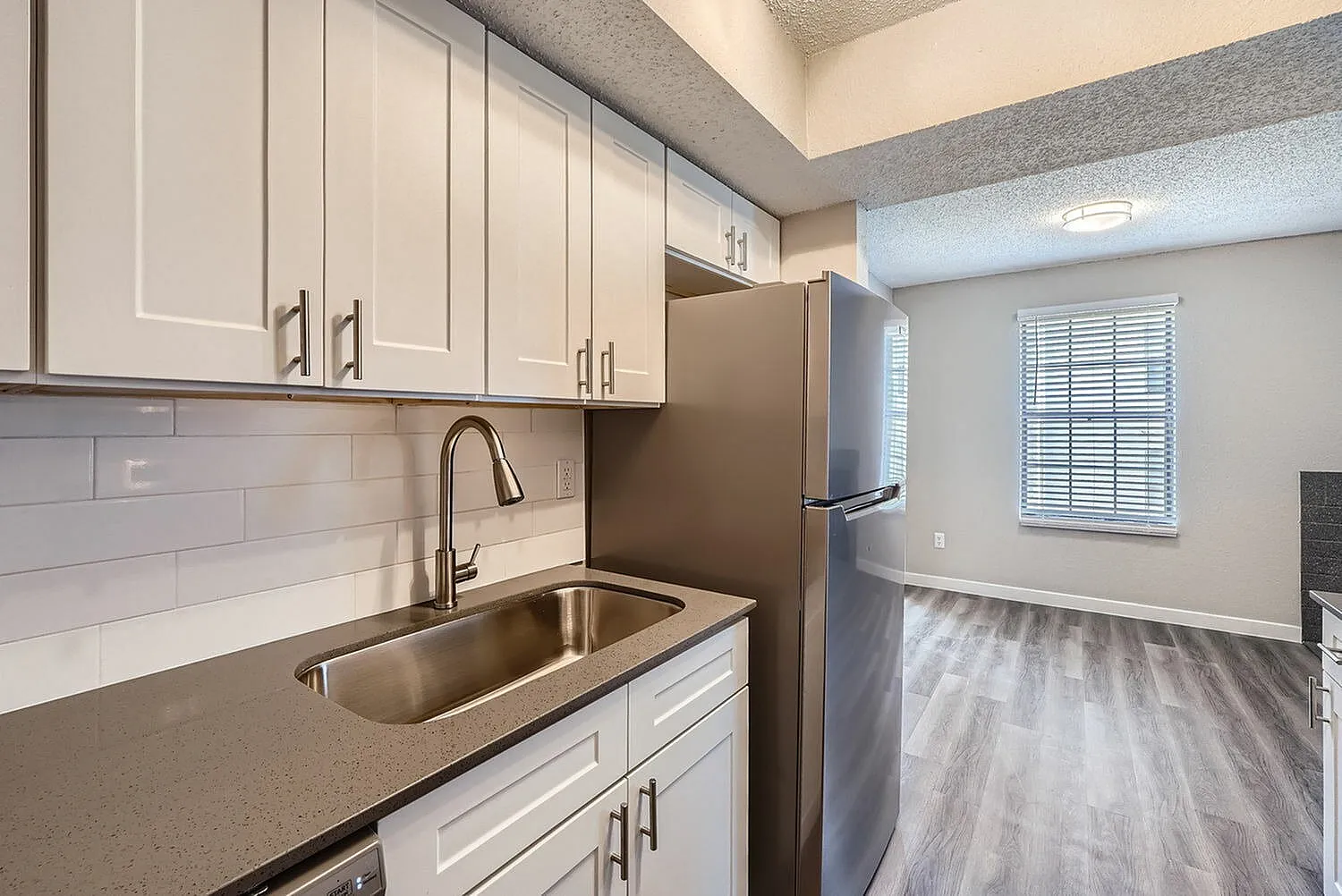 Kitchen, white shaker cabinetry, quartz countertops, stainless appliances, subway tile backsplash