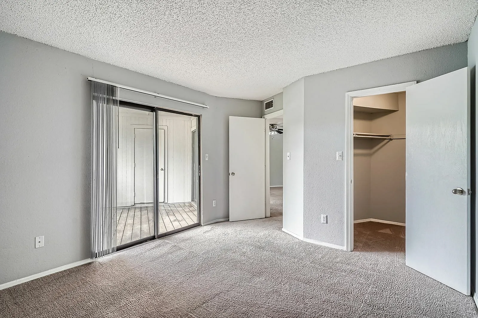 Primary bedroom, mirrored closet doors, carpet flooring, multiple closet spaces