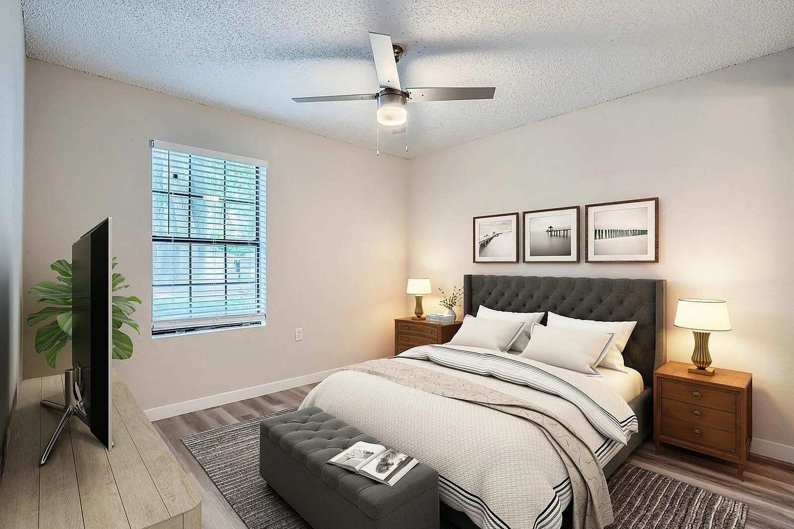 Primary bedroom, upholstered headboard, wood-style plank flooring, ceiling fan, bedside nightstands
