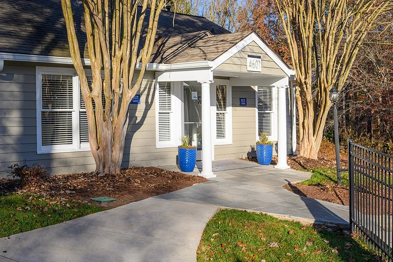 Home exterior, white columns, blue planters, tall trees, concrete pathway, Raleigh