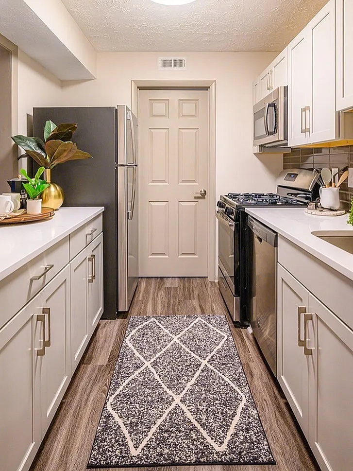 Kitchen, white shaker cabinetry, white quartz countertops, stainless appliances, wood-style plank flooring
