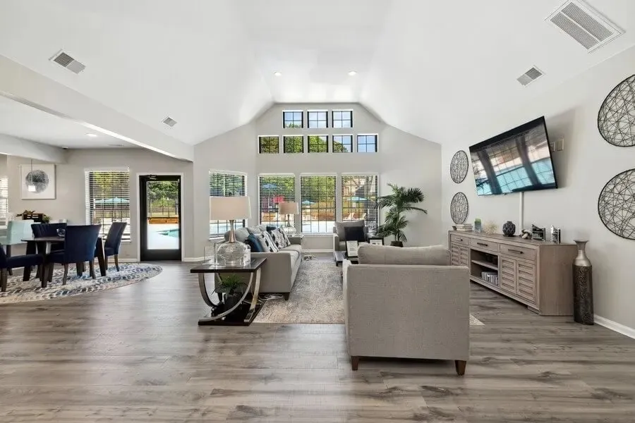 Clubhouse lounge, vaulted ceiling, wood-style plank flooring, pool views