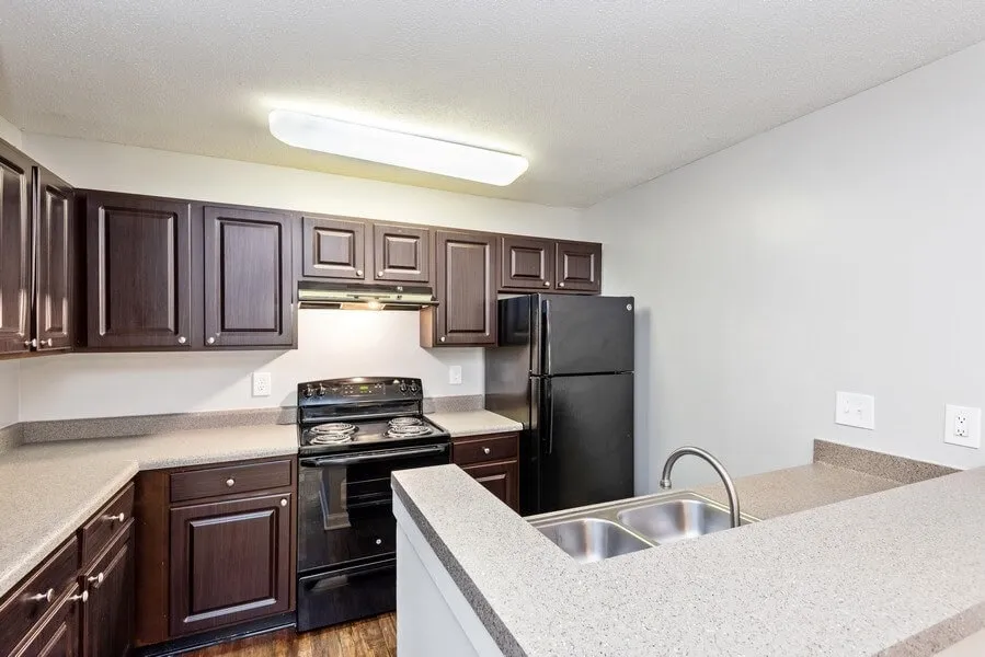 Kitchen, dark wood cabinets, laminate countertops, breakfast bar