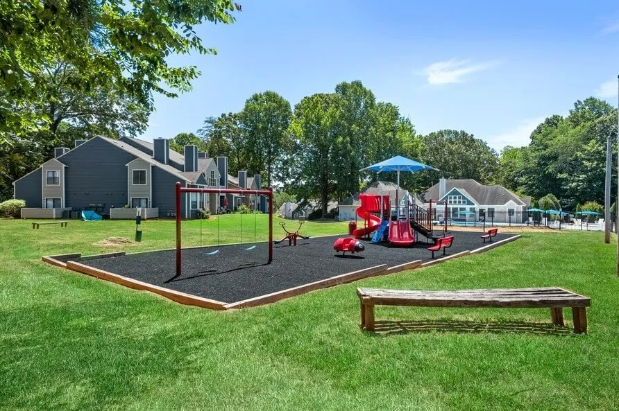 Community playground, swing set, rubber safety surface, open lawn