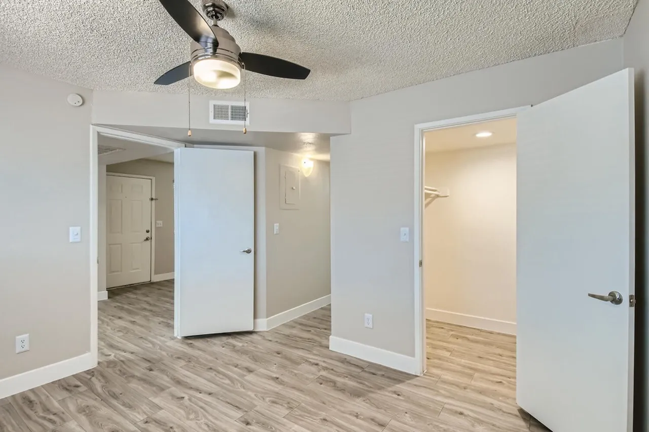 Bedroom with ceiling fan and walk-in closet