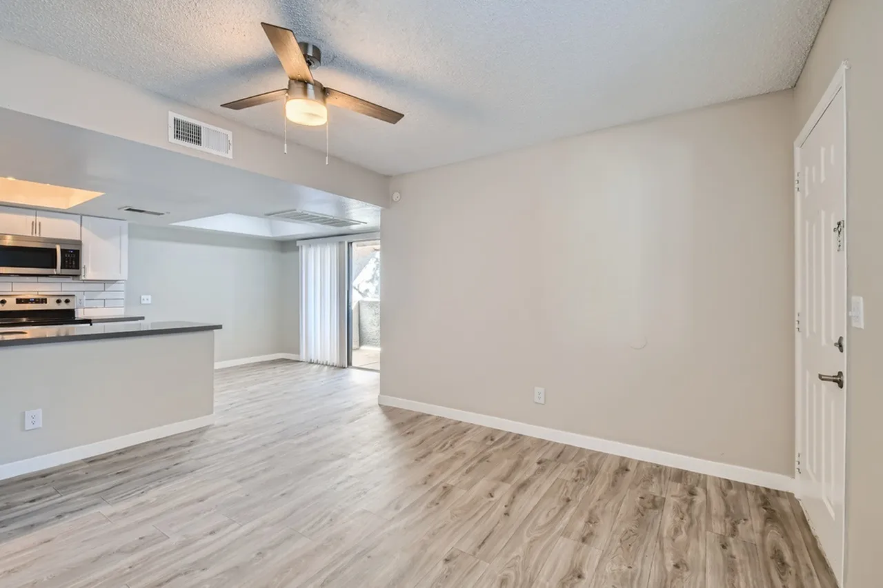 Living area leading to dining space and patio door