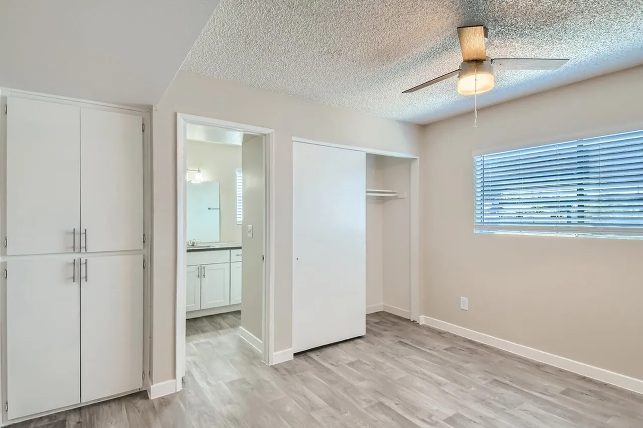 Bedroom with closet and bathroom entry