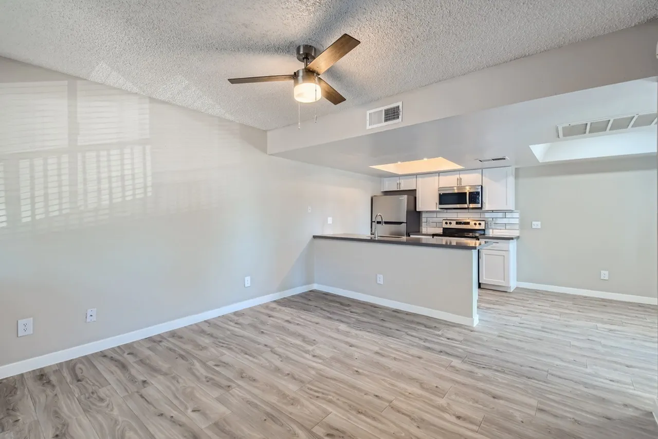 A2 Platinum living room open to kitchen with wood-style plank flooring