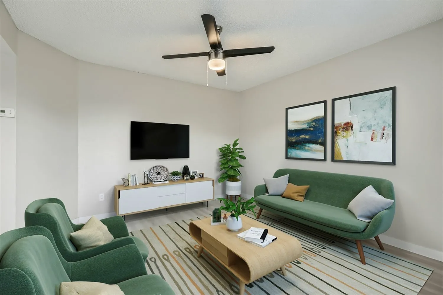 Living room with ceiling fan and neutral walls
