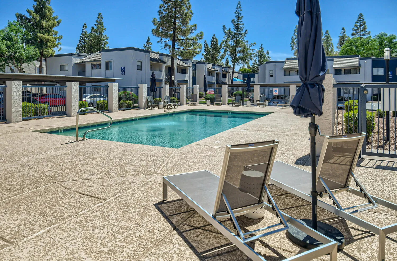 Resort-style swimming pool with lounge chairs