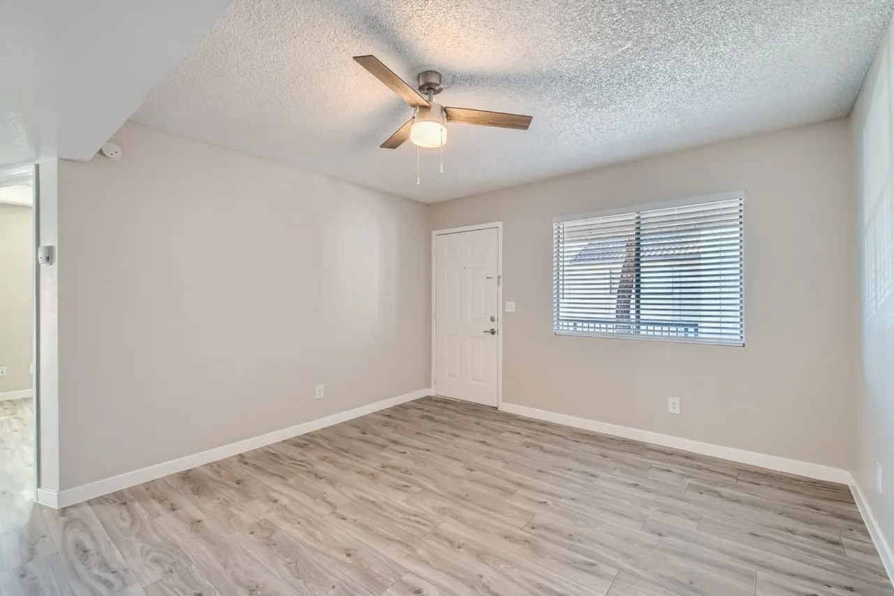 Living room with front door and window