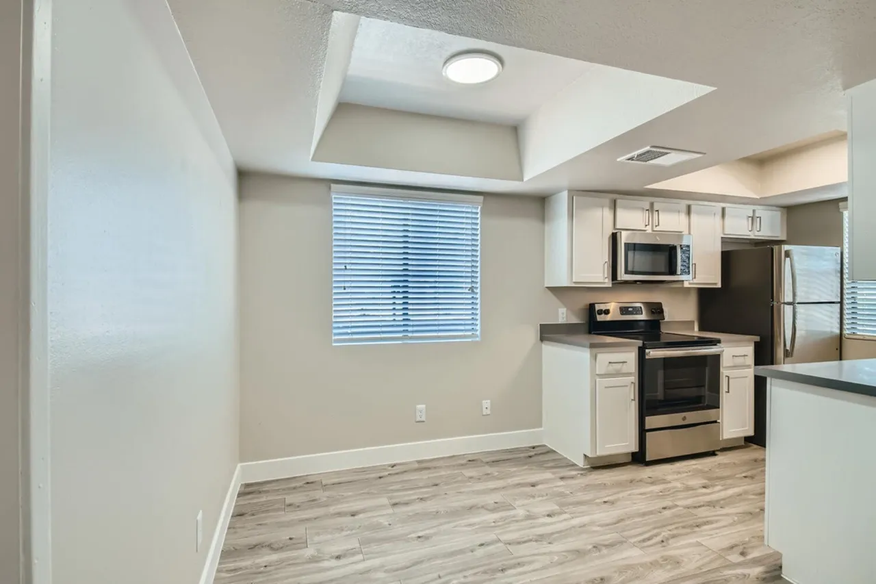 Dining space with tray ceiling beside kitchen