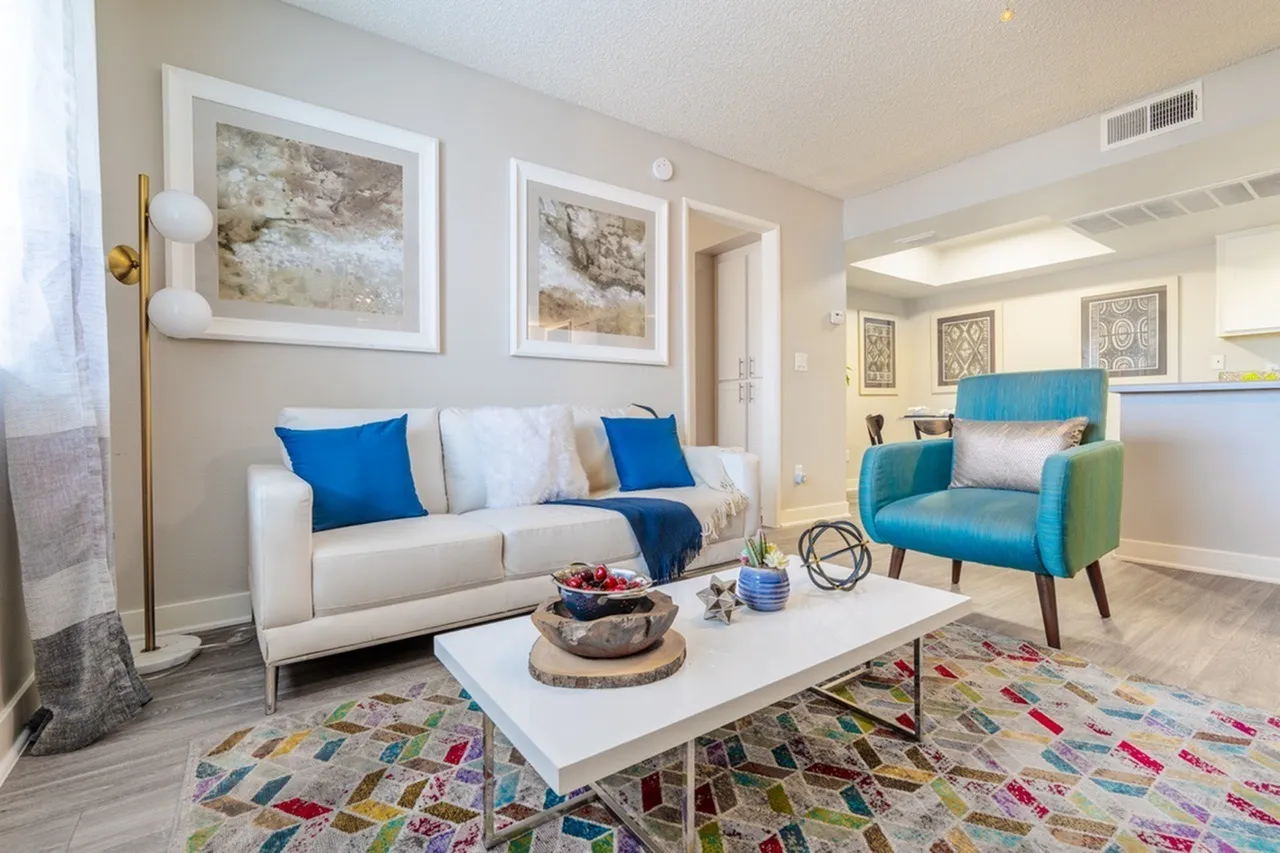 Open living area with view toward hallway and tray ceiling