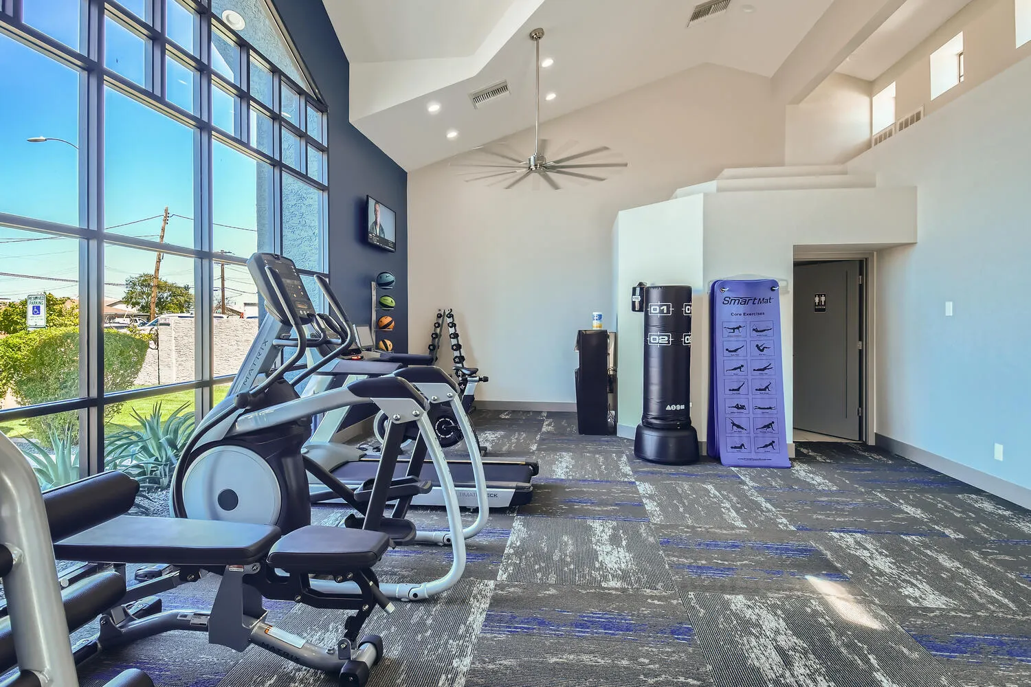 Apartment fitness center with treadmill, elliptical, and free weights
