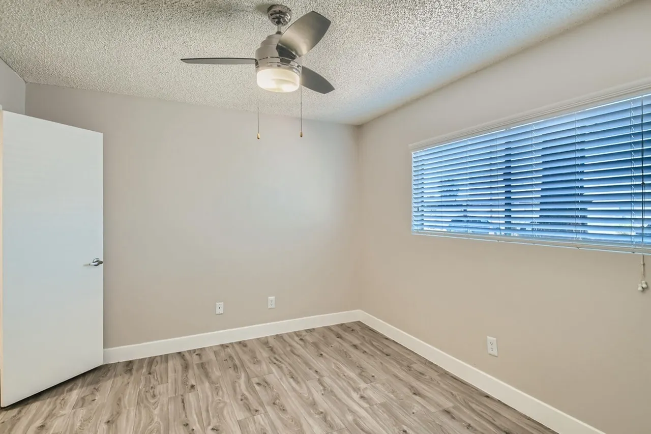 Bedroom with ceiling fan and window