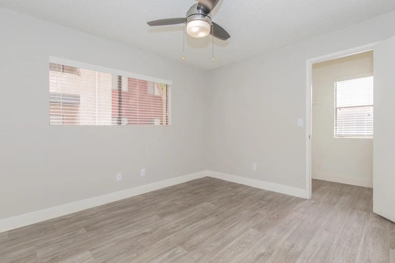 Bright bedroom with ceiling fan and window