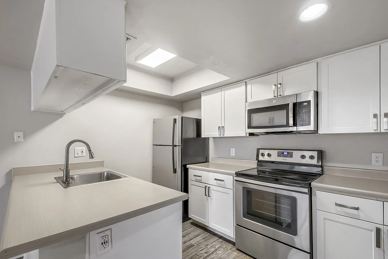 Kitchen with stainless steel appliances and white cabinets
