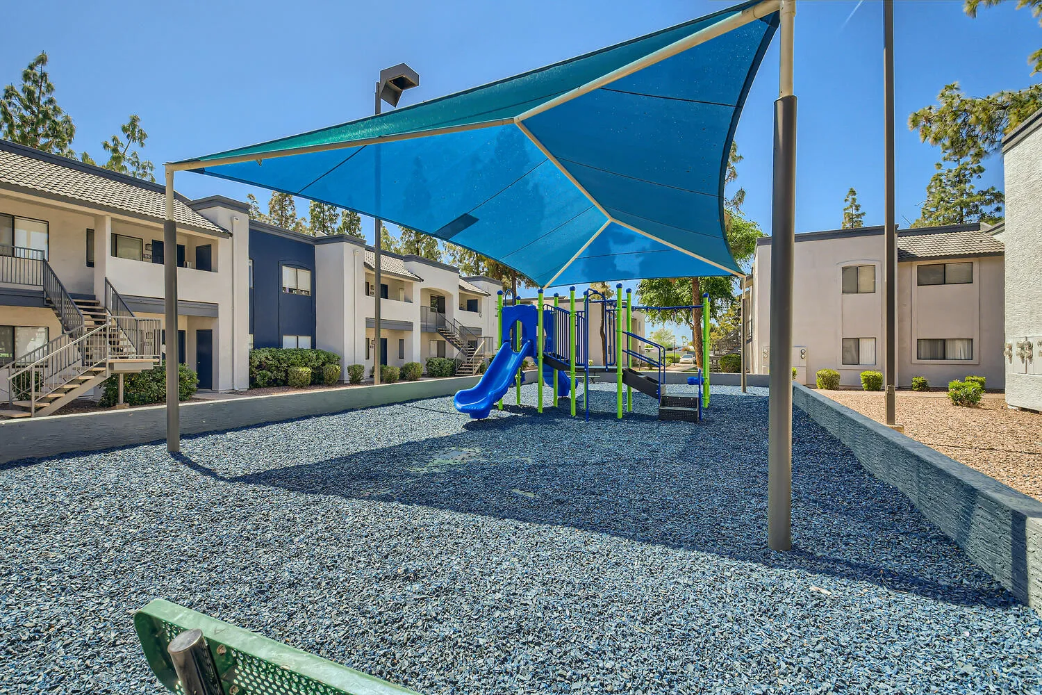 Shaded playground with slide