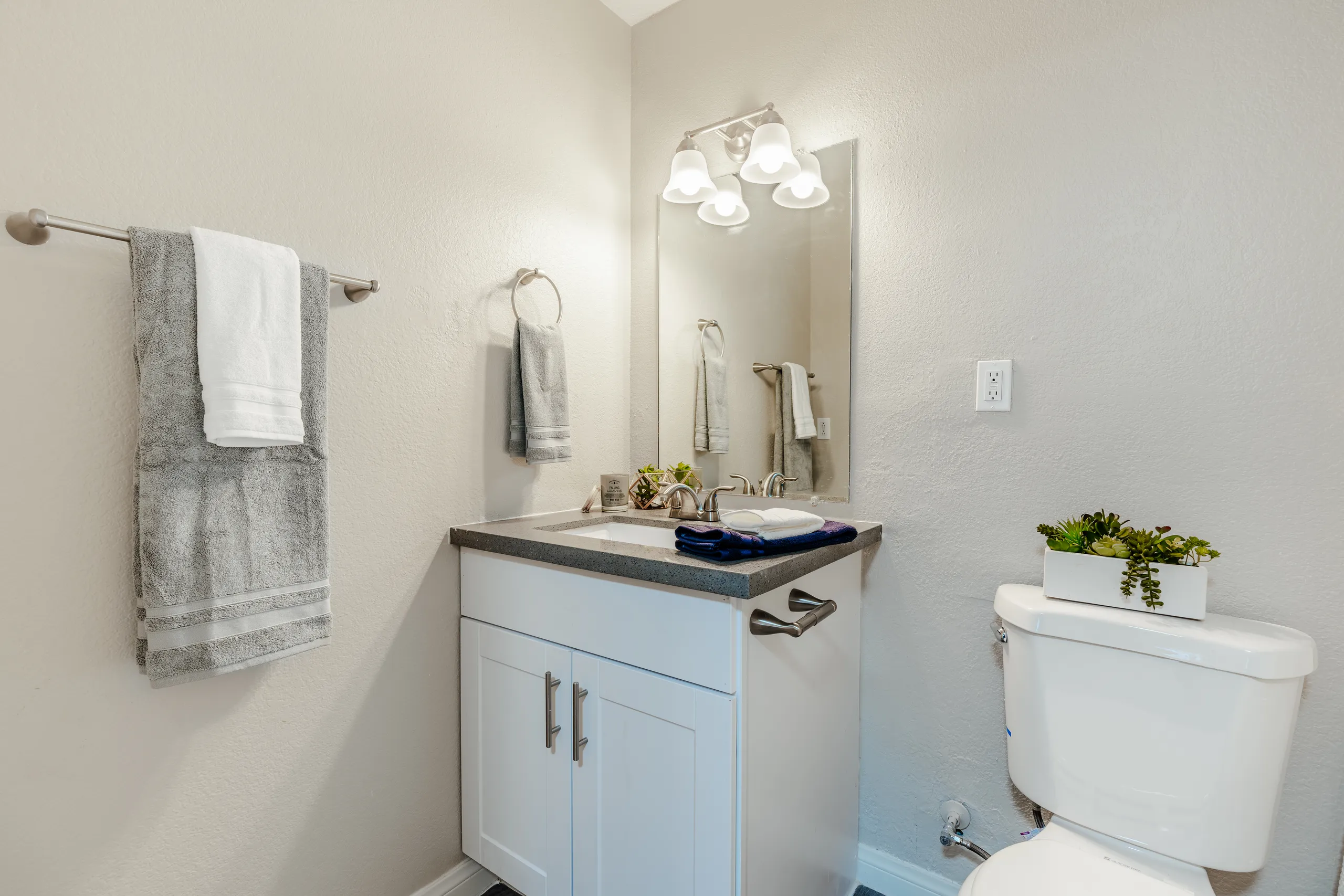 Bathroom vanity with framed mirror and vanity lighting