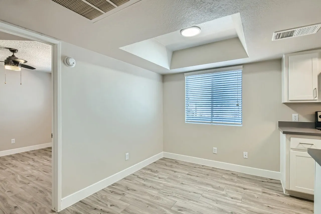 Dining nook with window and recessed ceiling