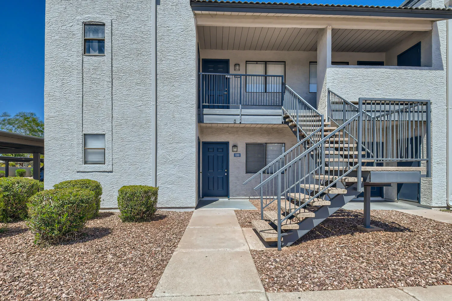 Two-story apartment building exterior with staircase