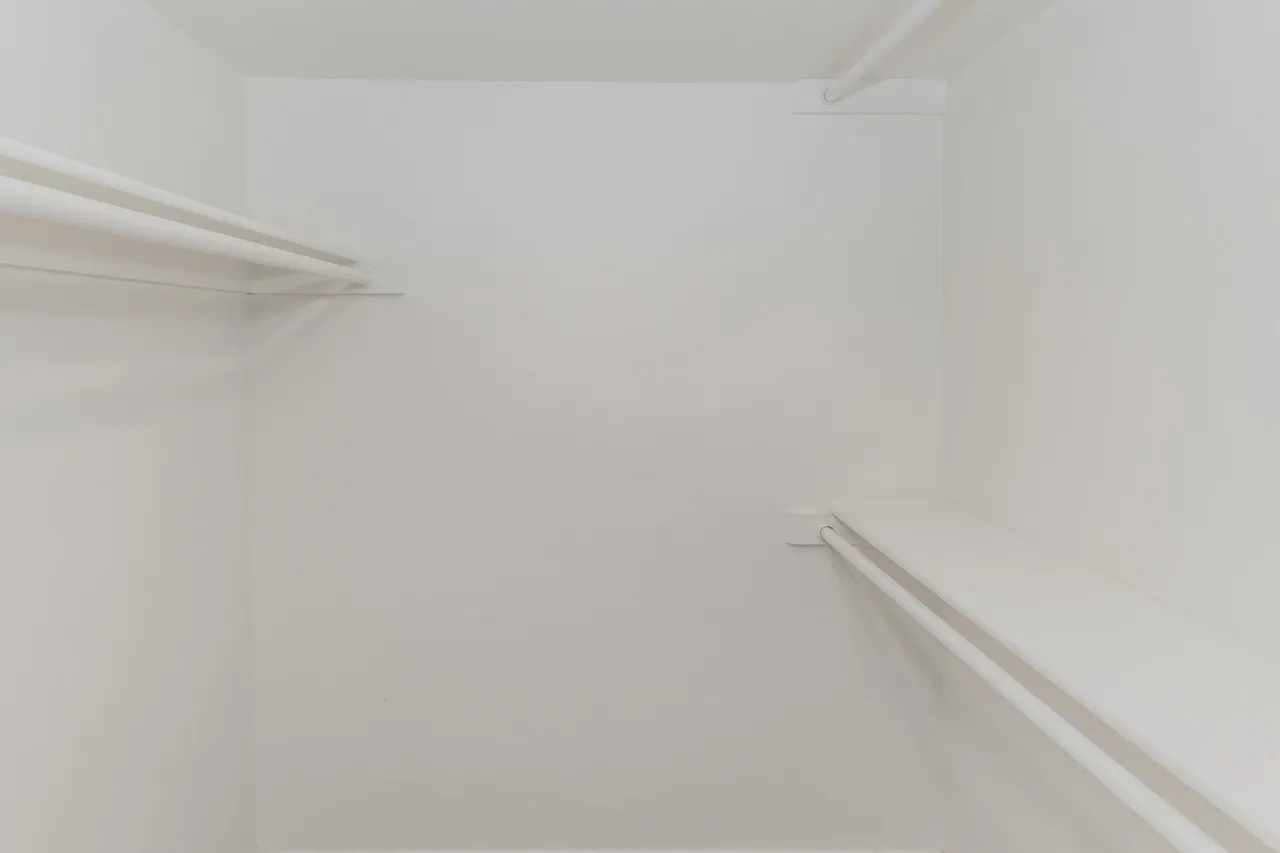 Walk-in closet with shelving and hanging rods