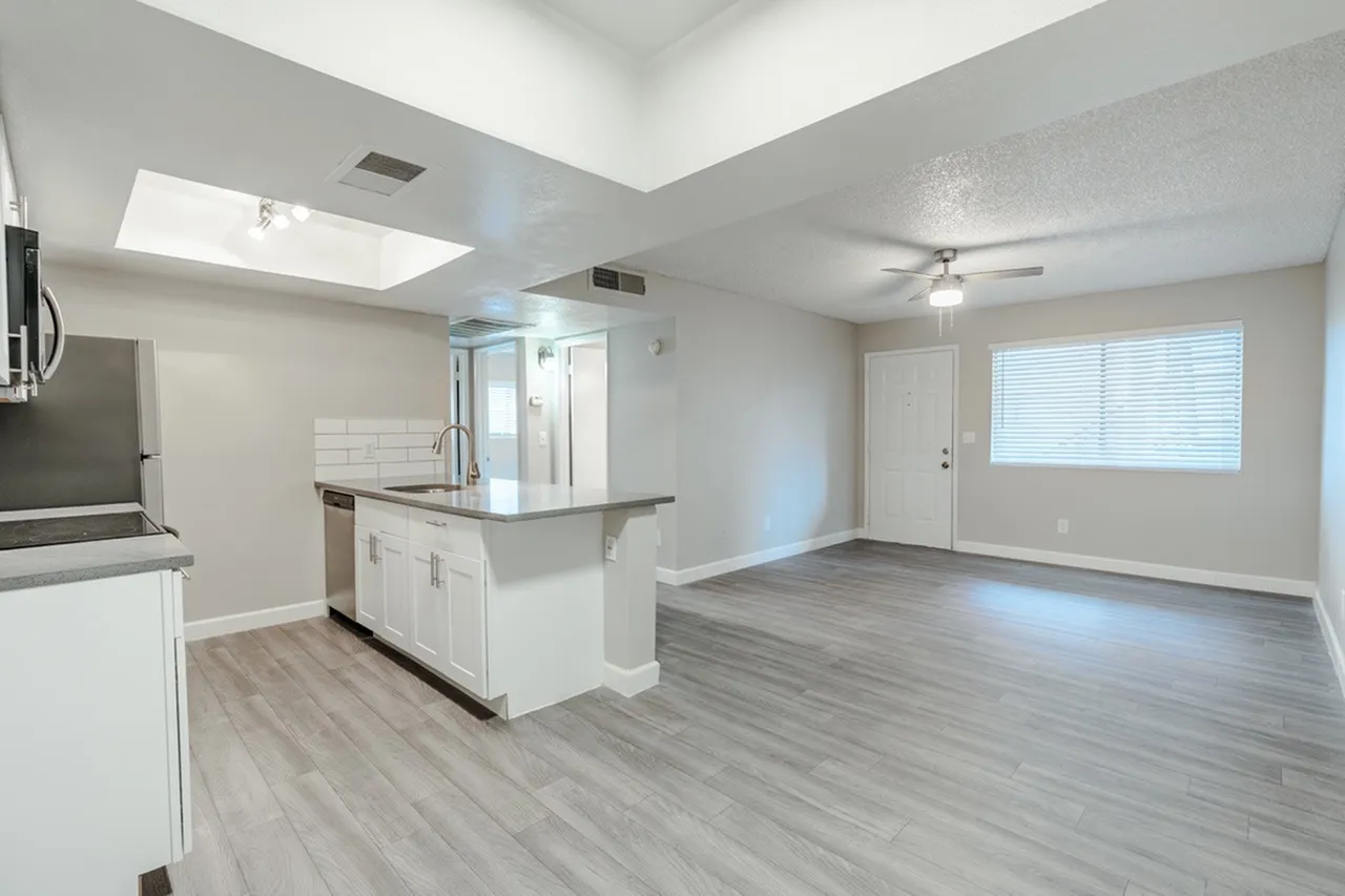 Kitchen island with sink facing living space and front entry