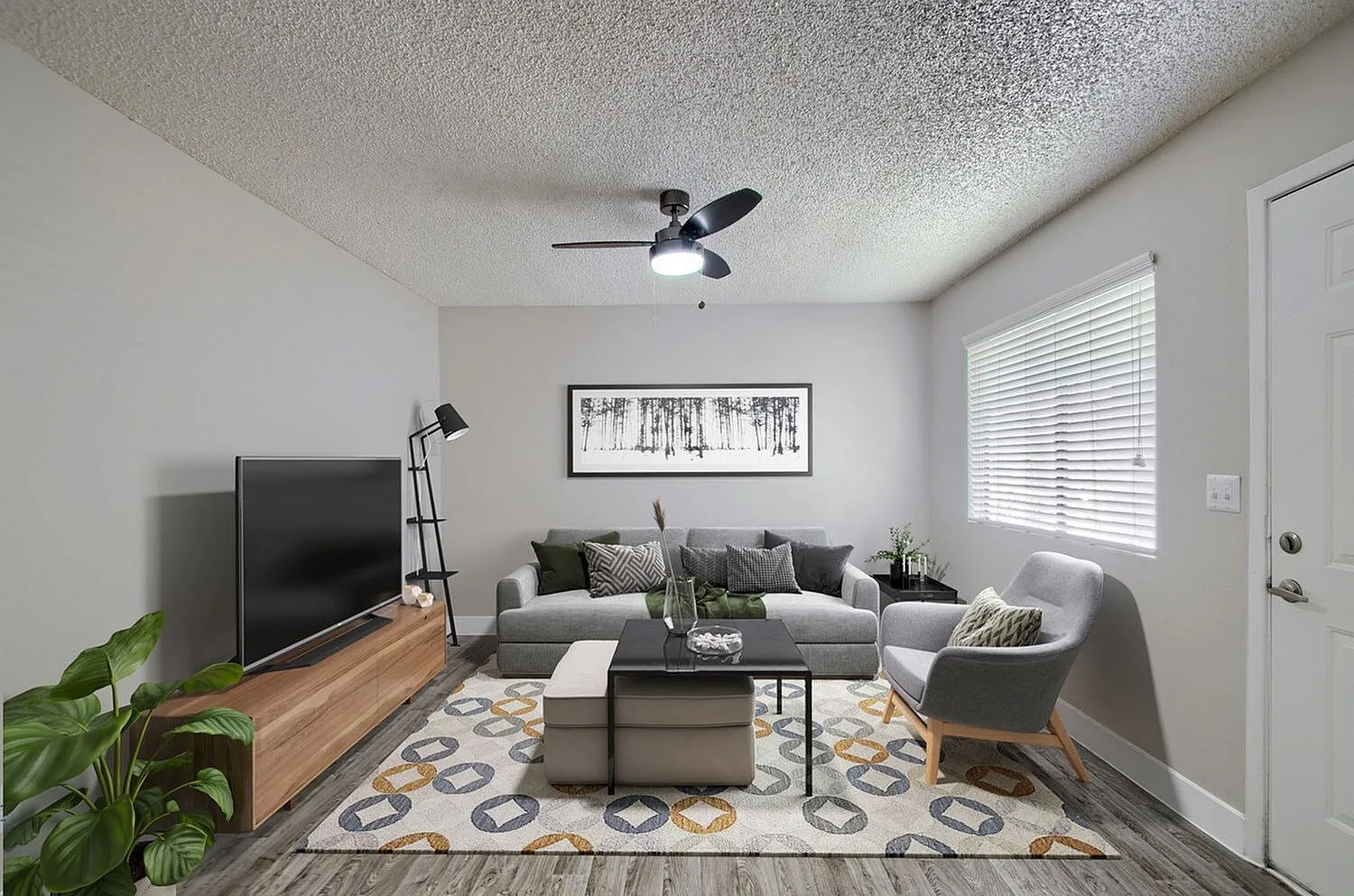 Living room with ceiling fan and dual windows
