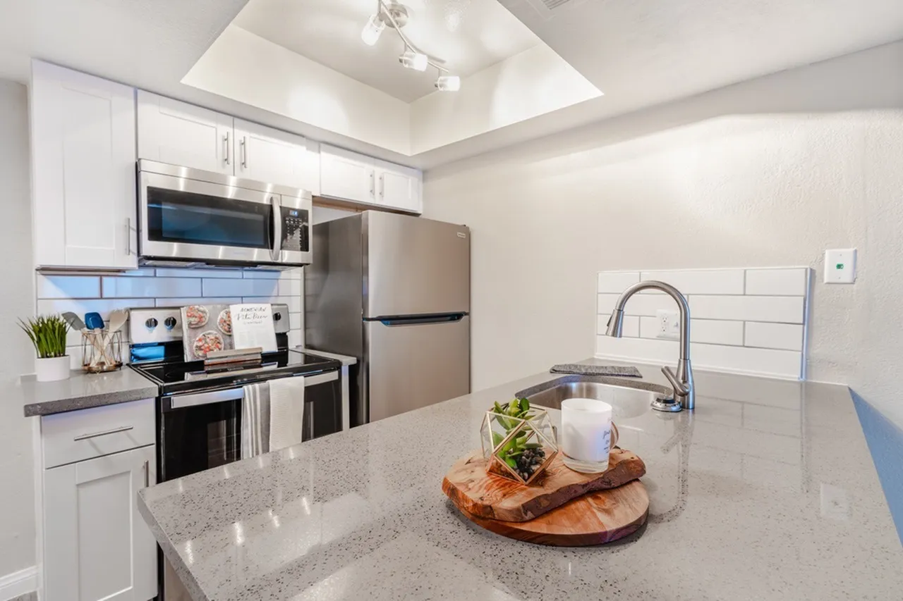 Countertop with gooseneck faucet and subway tile