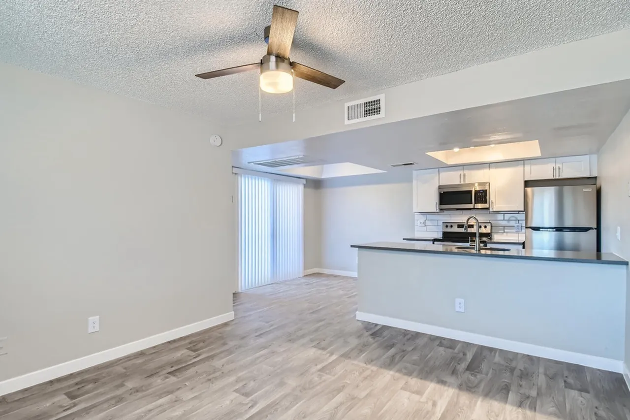 Living room open to kitchen and sliding patio door