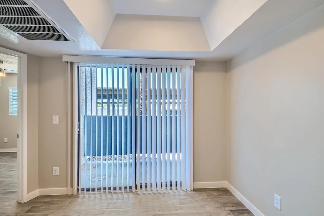 Dining area with vertical blinds and patio access