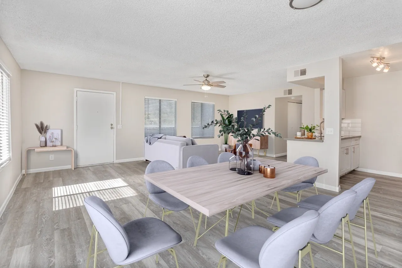 Dining area, wood-style plank flooring, white dining table, upholstered chairs, ceiling fan