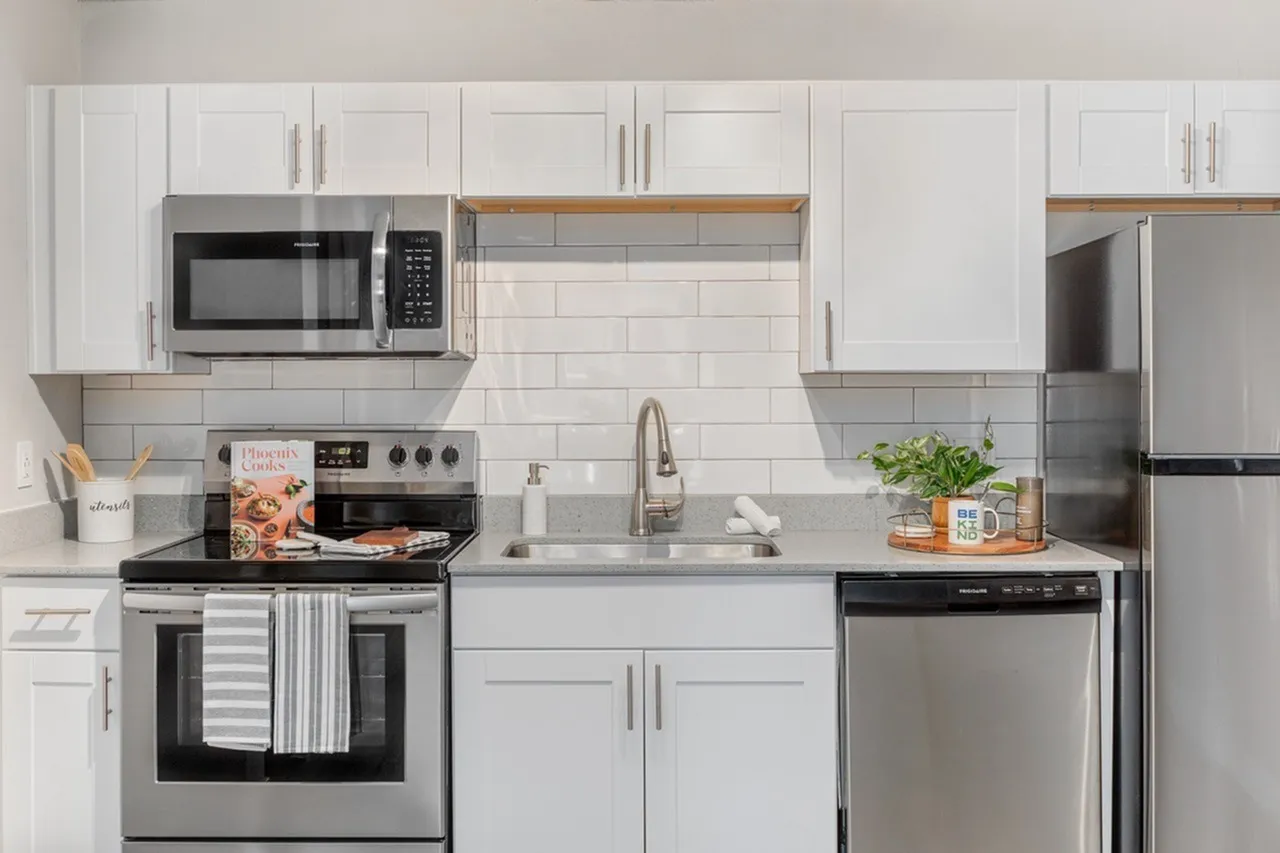 Kitchen, white shaker cabinetry, gray quartz countertops, stainless steel appliances, subway tile backsplash