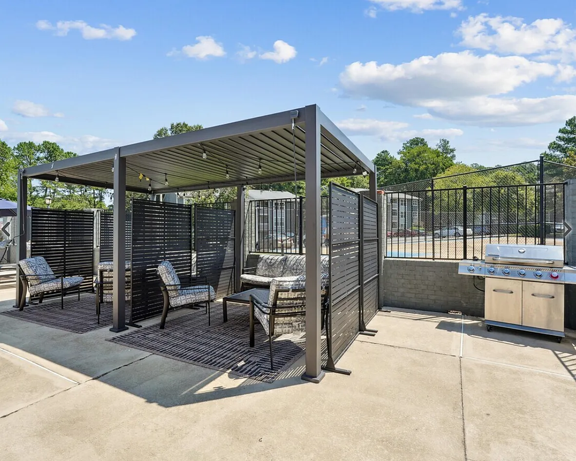 Rooftop amenity space, modern metal pergola, lounge seating, outdoor kitchen, fencing