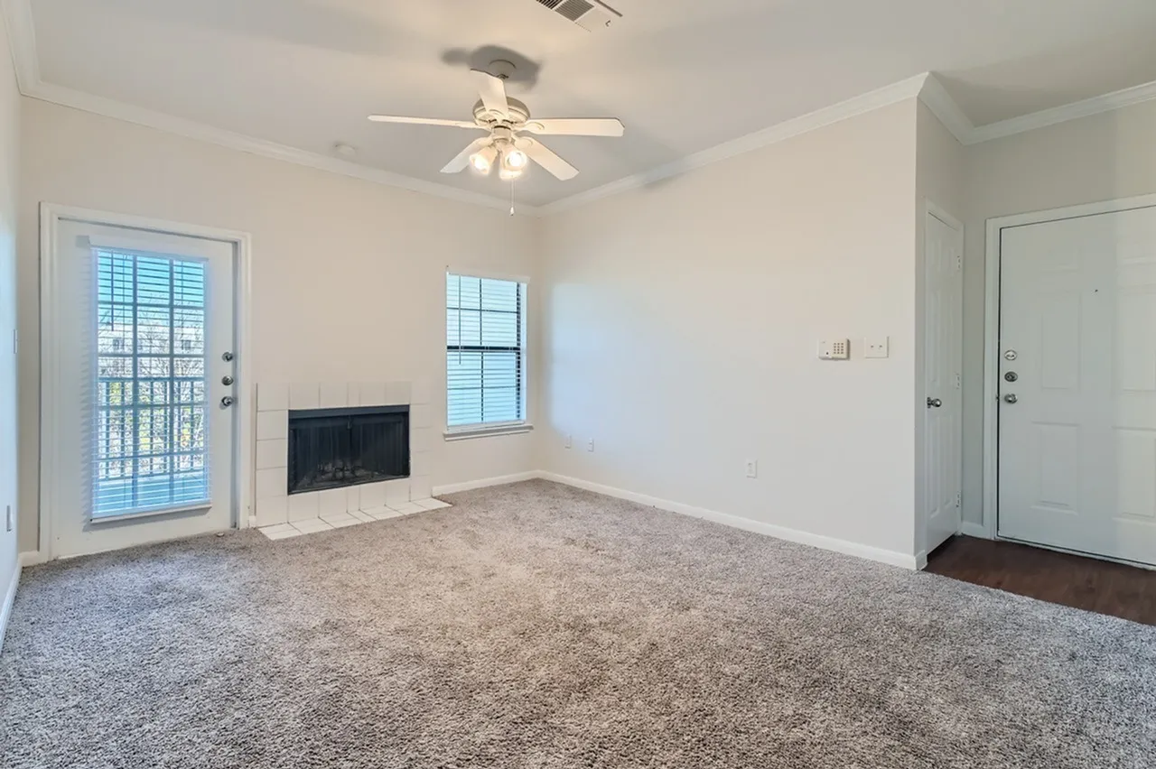 Living room, carpet flooring, fireplace, glass patio door, ceiling fan