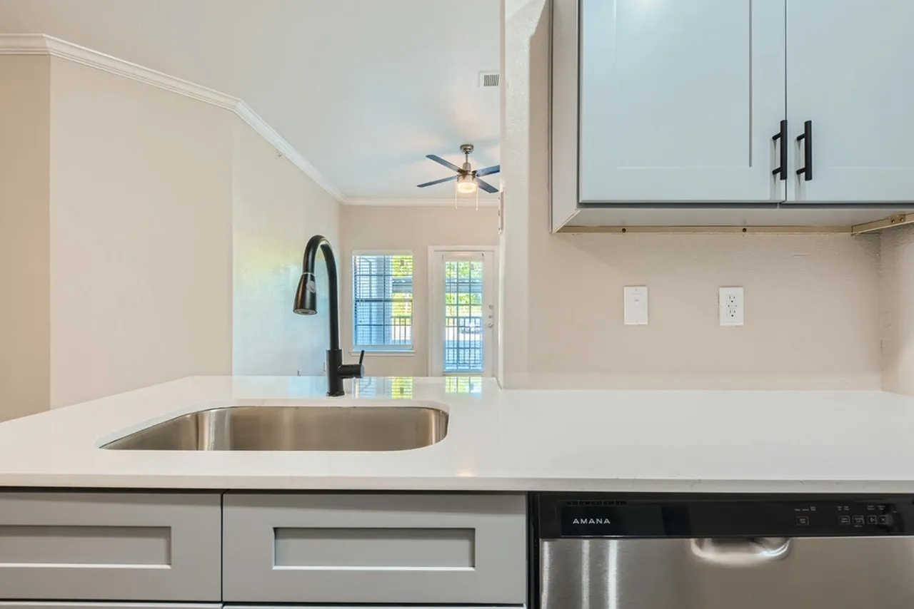 Kitchen, white quartz countertops, stainless steel sink, blue cabinetry, stainless appliances